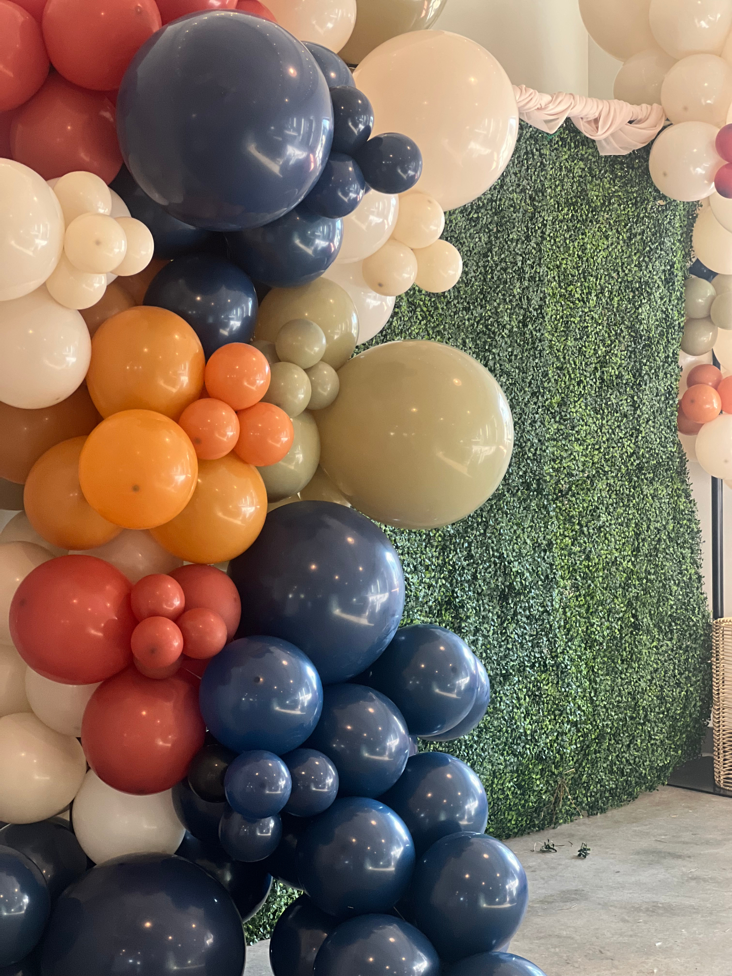 Organic balloon garland in navy, terracotta and sand