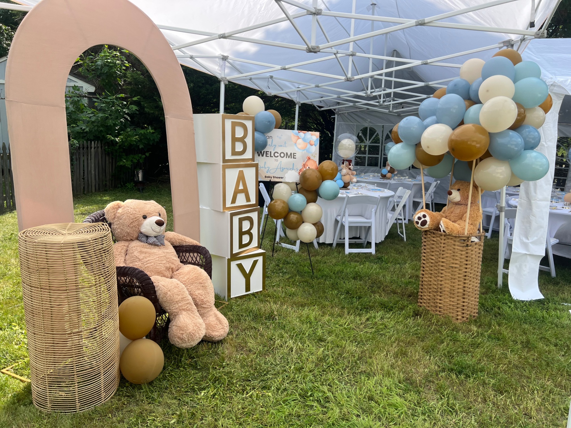 Teddy bear baby shower with blush arch and balloon clusters